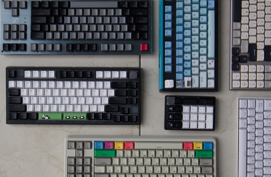 a-collection-of-computer-keyboards-and-mouses-on-a-table-pefz-dw-naq